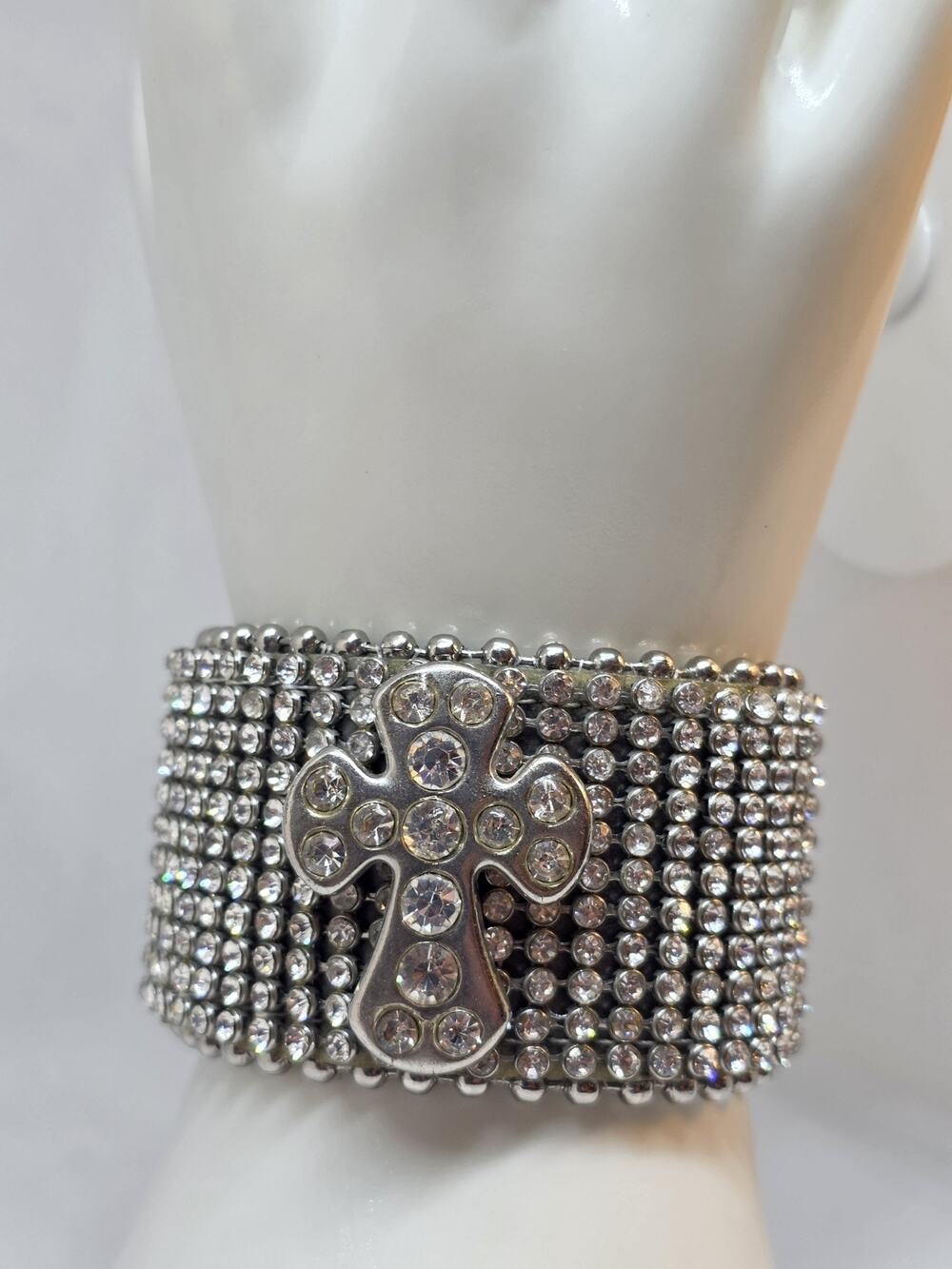 Encrusted rhinestone leather cuff embellished wi a rhinestone cross snap closure